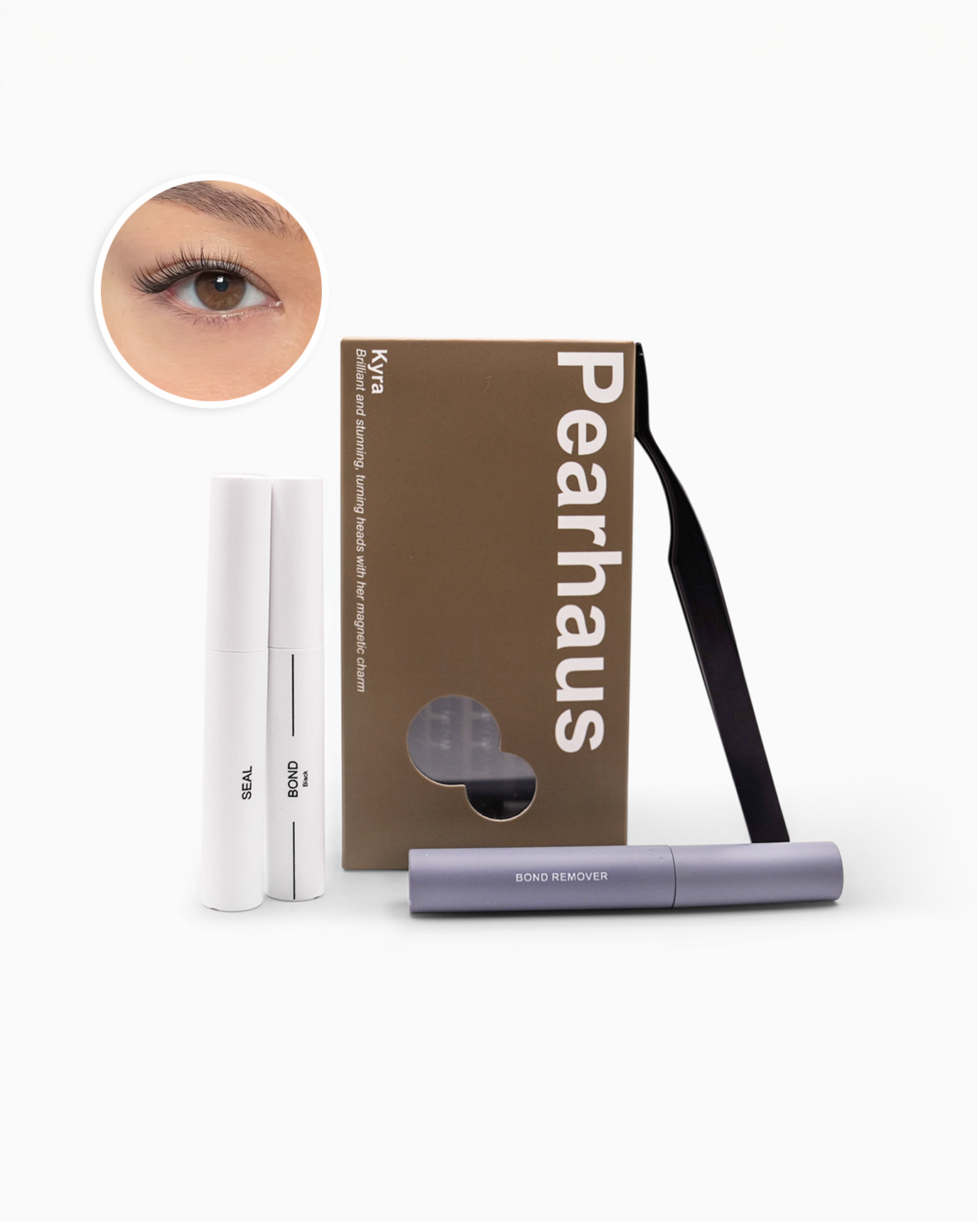 Pearlhaus brow and lash kit with a brown cardboard box, two white brow pens, and one lavender lash remover, plus a circular inset showing an eye close-up.